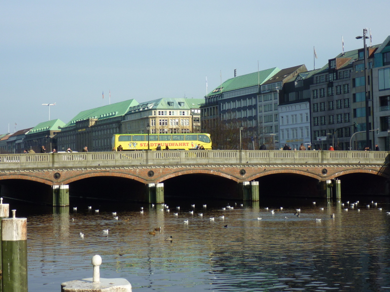 Downtown Hamburg: sightseeing bus on bridge over Alsterfleet
