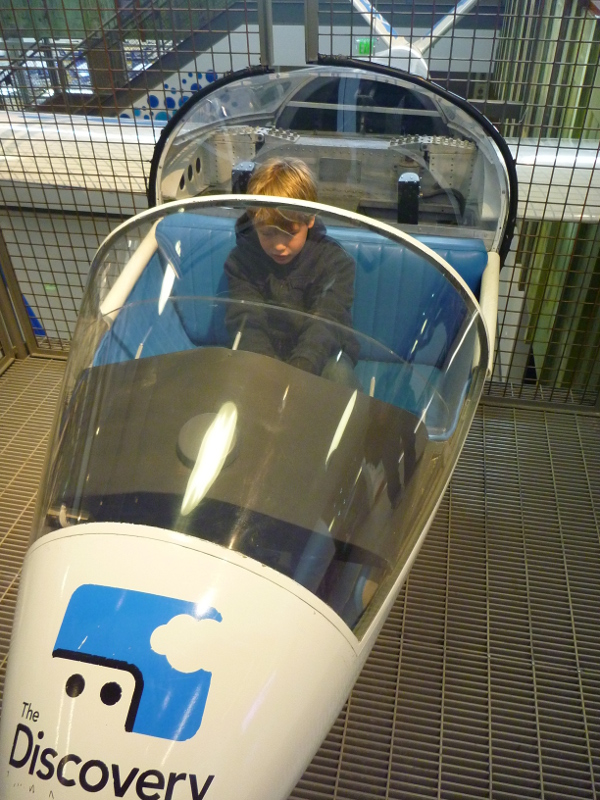 A little boy playing pilot at Reno's Discovery Museum